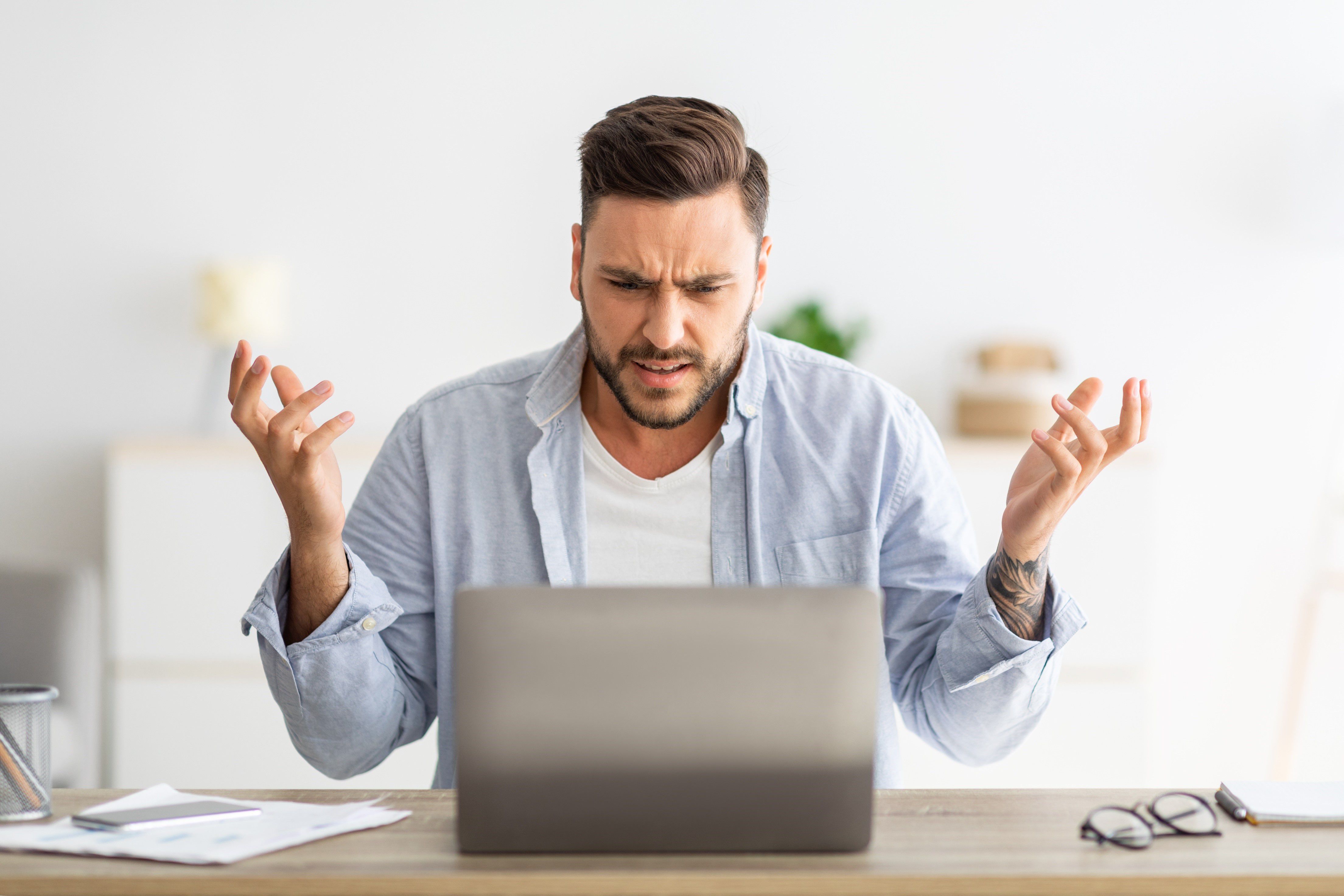 Une personne énervée devant son ordinateur, illustrant l'importance d'éviter les erreurs courantes dans la stratégie de marketing digital d'une entreprise.